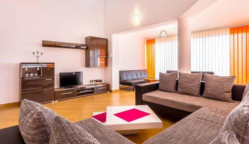 a living room with a couch and a tv at Villa Marcelia in Pula