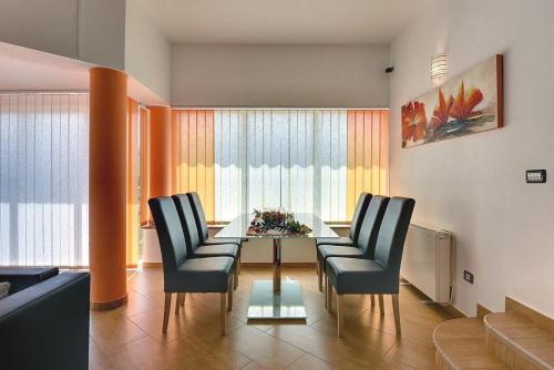 a living room with a glass table and chairs at Villa Marcelia in Pula