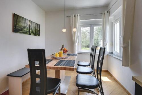 a dining room table and chairs in a room at Villa Marcelia in Pula
