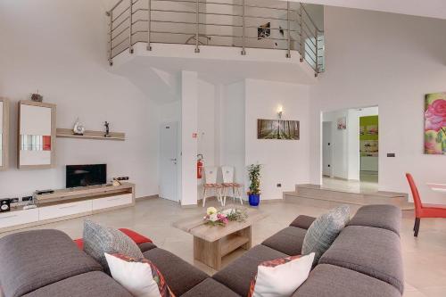 a living room with a couch and a table at Villa Marcelia in Pula