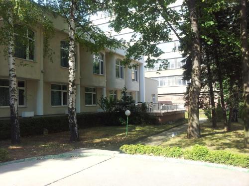 a building with trees in front of it at Hostel Elena in Sofia