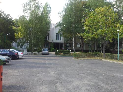 a parking lot with cars parked in front of a building at Hostel Elena in Sofia