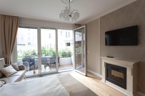 a living room with a fireplace and a tv at Sofie Apartments in Vienna