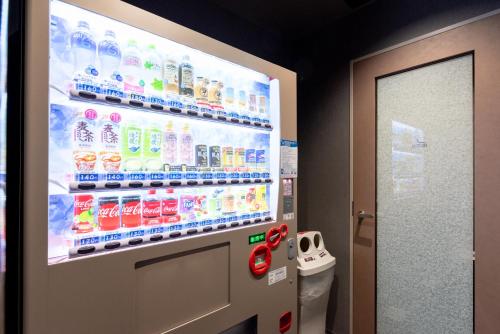a vending machine filled with bottles of soda at Hiyori Hotel Osaka Namba Station in Osaka