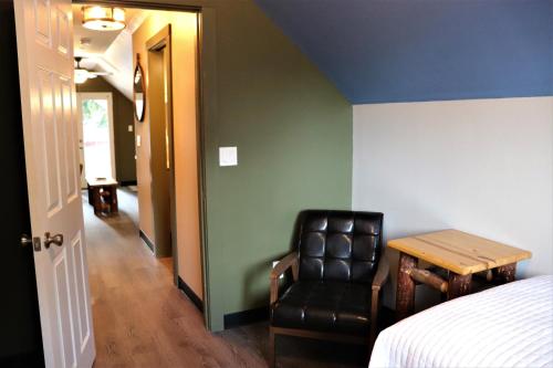 a room with a bed and a table and a chair at Lone Fir Resort in Cougar