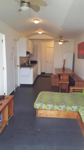 a living room with a bed and a kitchen at Arco Iris Atacames in Atacames
