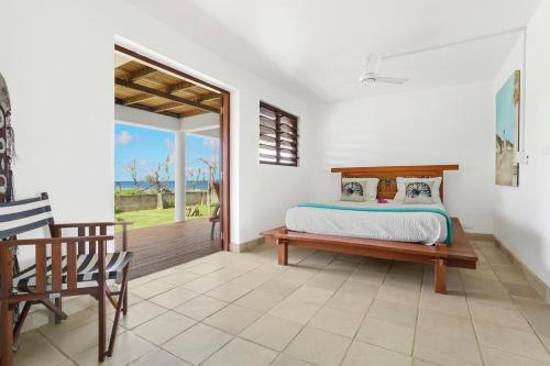 - une chambre avec un lit et une porte coulissante en verre dans l'établissement Villa Senang Masari, à Poussabier