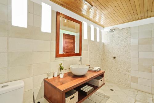 bagno con lavandino e specchio di Villa Senang Masari a Poussabier