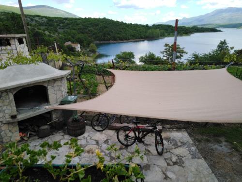 a bike parked next to a tent with a view of a river at Holiday home Marija in Vrlika