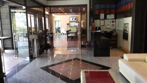 a lobby with a glass door and a floor at Mokkoji Pension in Hadong