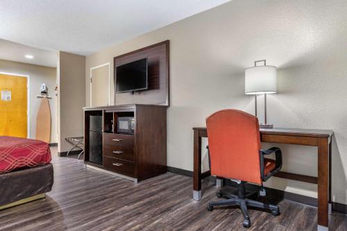 a hotel room with a desk and a chair at Econo Lodge Florence - Darlington in Florence