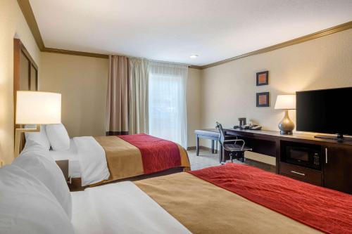 a hotel room with two beds and a desk at Comfort Inn Castro Valley in Castro Valley