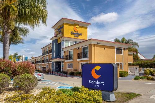 a sign in front of a building with a c comfort inn at Comfort Inn Castro Valley in Castro Valley
