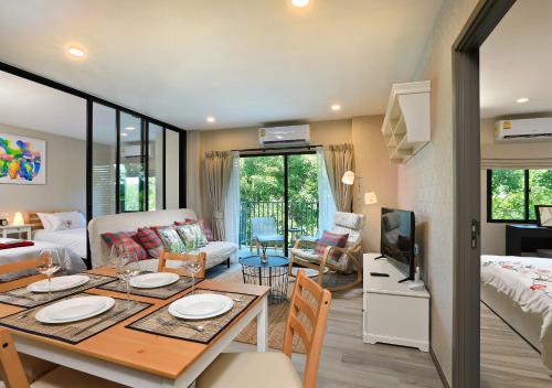 a living room with a dining table and a living room at NaiYang beach Title Residencies by My Home Phuket in Nai Yang Beach