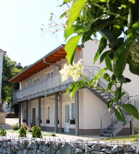 a building with a balcony and stairs at Pension Am Ziegelwall in Bautzen