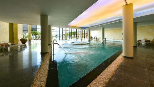 a large swimming pool in a large building with a swimming pool at Kempinski Hotel Ishtar Dead Sea in Sowayma