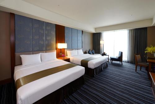 Ένα ή περισσότερα κρεβάτια σε δωμάτιο στο Fullon Hotel Tamsui Fishermen's Wharf