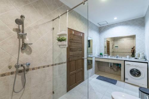 a bathroom with a shower stall and a washing machine at AnB poolvilla 2BR with private beach in pratamnak in Pattaya South
