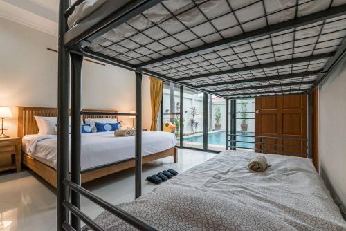a bedroom with two bunk beds and a balcony at AnB poolvilla 2BR with private beach in pratamnak in Pattaya South