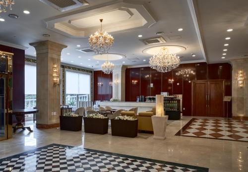 a lobby of a hotel with chandeliers at GoldOne Hotel & Suites in Seogwipo