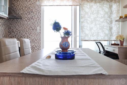 a vase with flowers in it sitting on a table at MOUSELIS APARTMENTS in Kalymnos