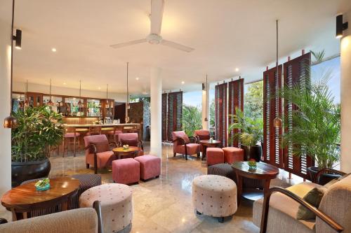 a restaurant with pink chairs and tables at Gending Kedis Luxury Villas & Spa Estate in Jimbaran