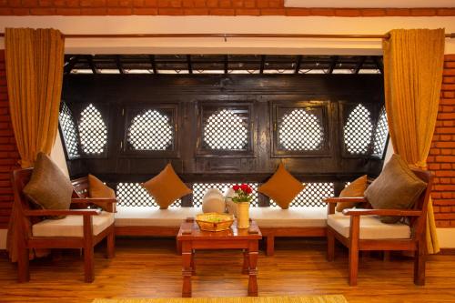 a living room with two chairs and a table at Nivas Boutique Home in Kathmandu