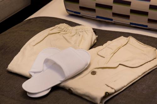 a pair of shorts and a sweater on a table at Hotel Monterey Le Frere Osaka in Osaka