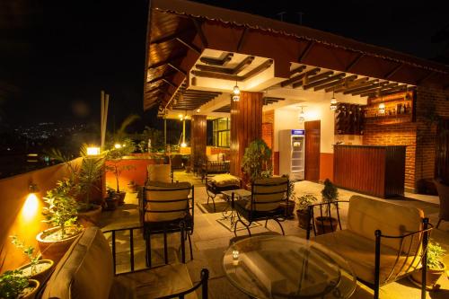a patio with chairs and tables and a building at Nivas Boutique Home in Kathmandu
