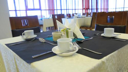 a table with plates and utensils on top at Haile Resort-Gondar in Gonder