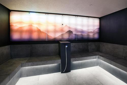 a room with a large screen on the wall at Hotel Truyenhof in Ried im Oberinntal