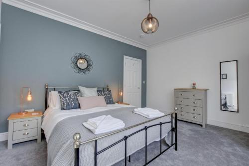 a bedroom with a large bed and two night stands at Beyond the Harbour in Whitby