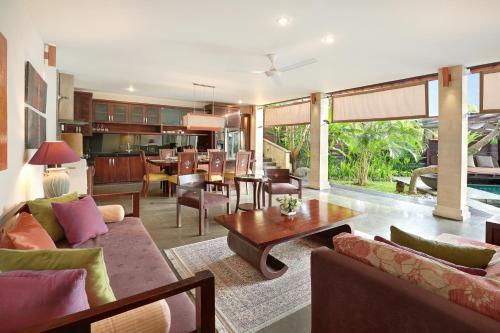 an open living room with a dining room and kitchen at Gending Kedis Luxury Villas & Spa Estate in Jimbaran