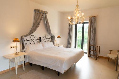 a bedroom with a bed and a chandelier at Hotel Villa Marcilla in Marcilla