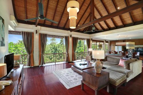 a living room with a couch and a table at Gending Kedis Luxury Villas & Spa Estate in Jimbaran