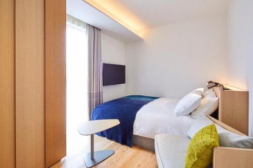 a hotel room with a bed and a couch at TSUKI Tokyo in Tokyo