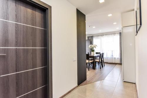 a kitchen and dining room with a sliding door at Amber - Luxury Two Bedroom Apartment in Palanga