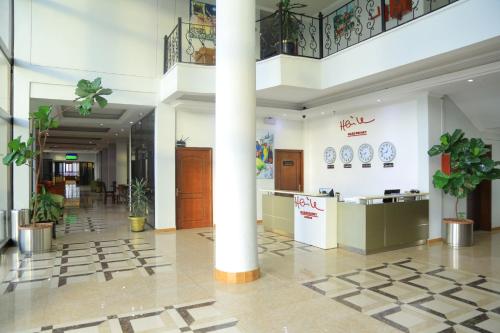 a lobby of a building with plants and a column at Haile Resort-Gondar in Gonder
