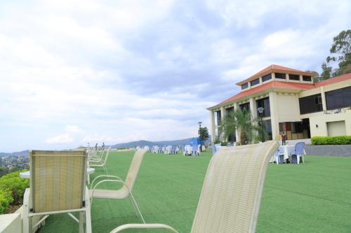 a group of chairs sitting on a lawn in front of a building at Haile Resort-Gondar in Gonder