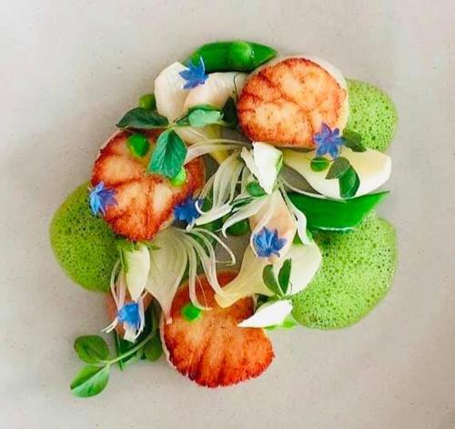 a plate of food with fruit and vegetables at 法國小古堡-Chateau de France in Wujie