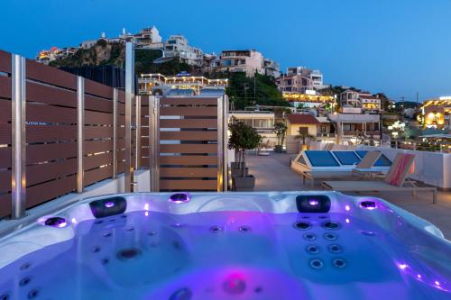 a bath tub sitting on top of a balcony at Angels Suites in Plataniás