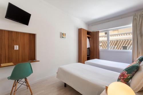 a hotel room with a bed and a tv at Next Inn in Portimão