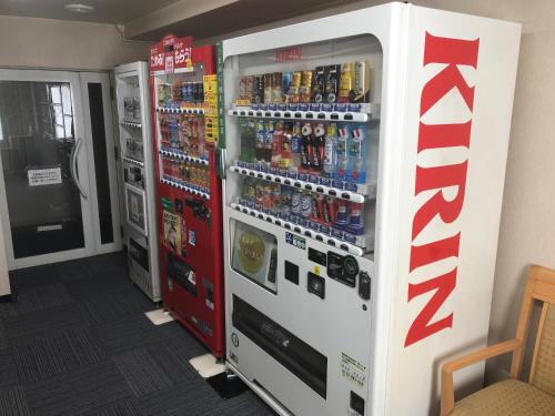 two coca cola vending machines in a room at Chitose Airport Hotel in Chitose