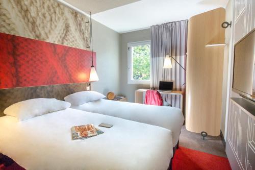 Habitación de hotel con 2 camas y ventana en ibis Brignoles Provence Verte, en Brignoles