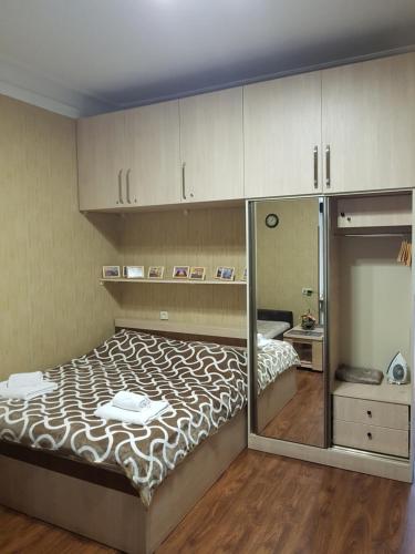 a bedroom with a large bed with a glass wall at Apartment in Tbilisi in Tbilisi City