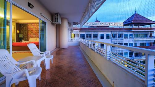 a balcony with white chairs and a view of the ocean at Kwan Ruen Park in Nakhon Ratchasima
