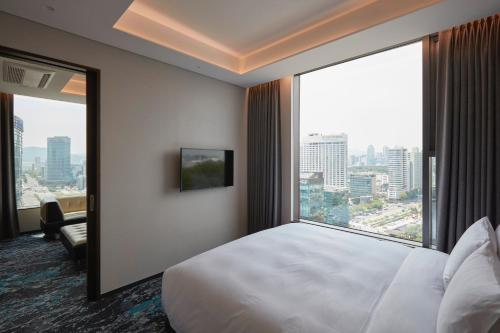 a hotel room with a large bed and a large window at HOTEL in 9 Gangnam in Seoul
