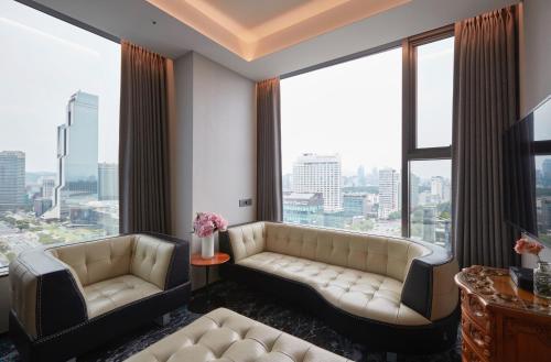 a living room with a couch and large windows at HOTEL in 9 Gangnam in Seoul