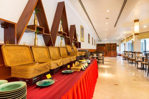 a restaurant with a long table with plates on it at Angkor Century Resort & Spa in Siem Reap
