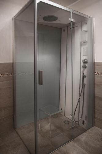 a shower with a glass door in a bathroom at La Villa in Salò
